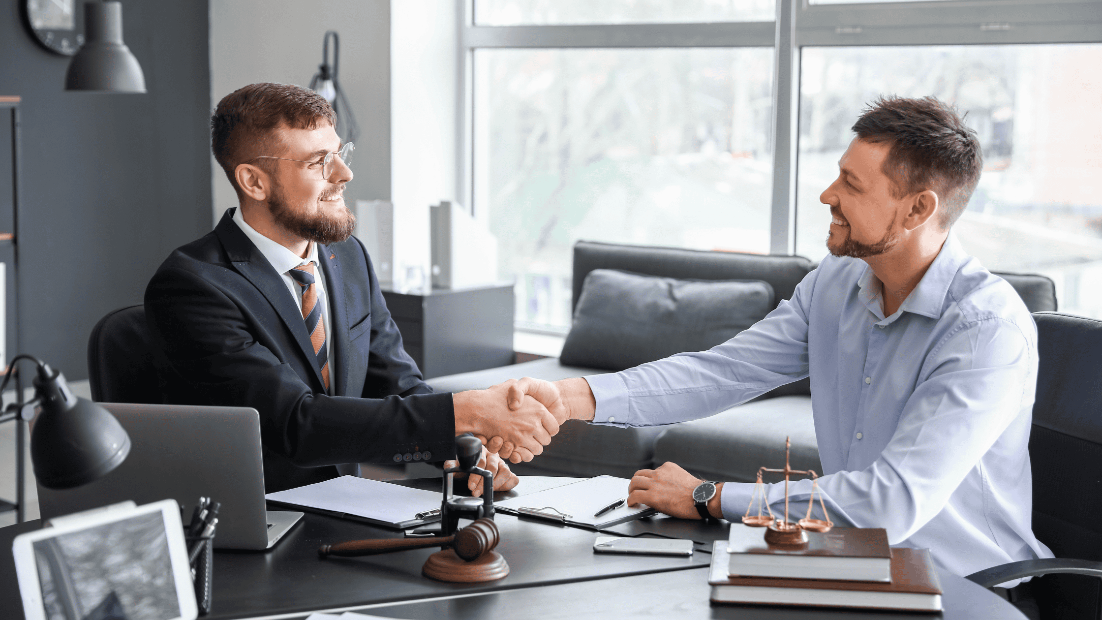 Two men shaking hands on a personal injury case.