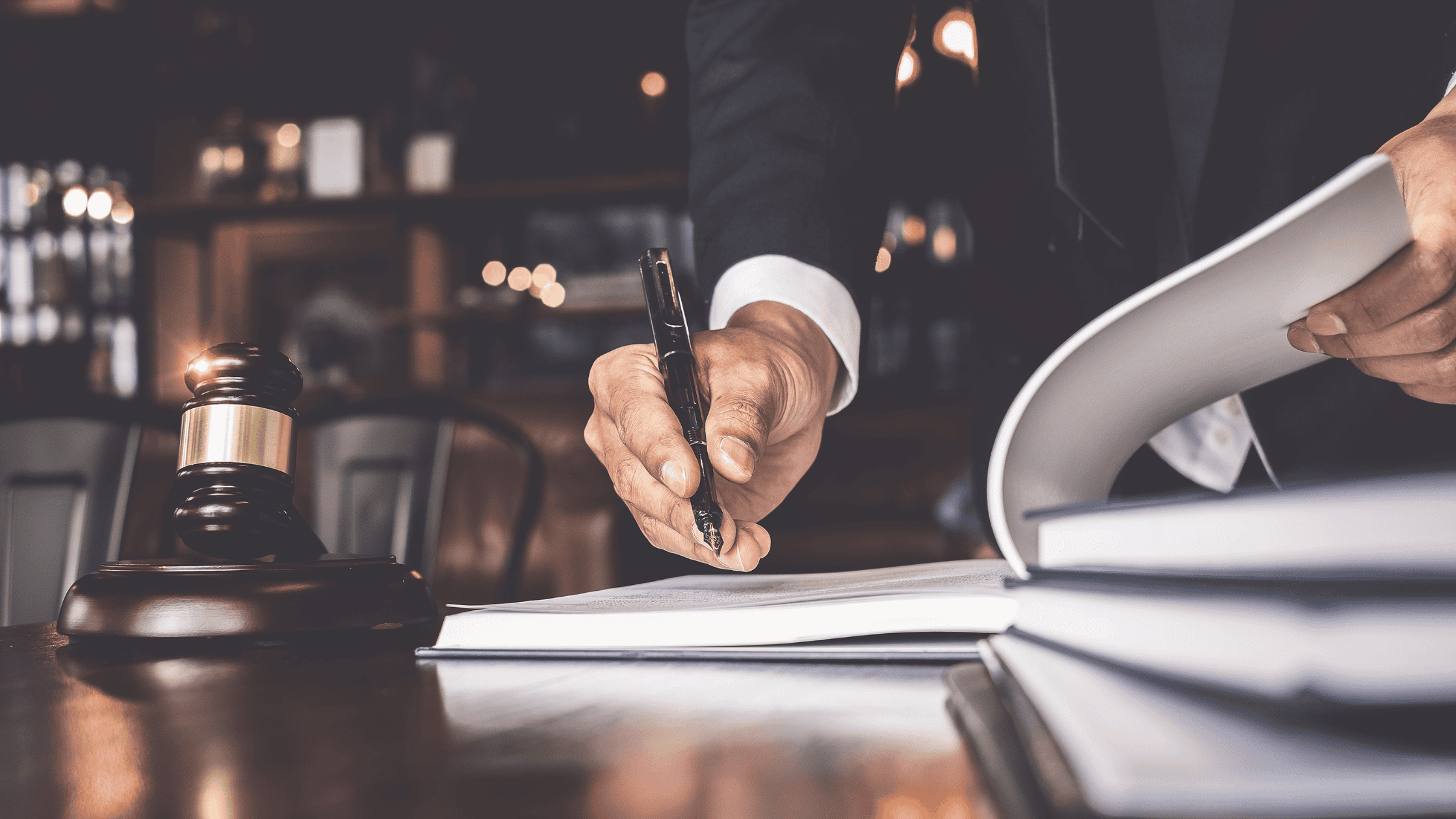 Personal injury lawyer signing a contract.