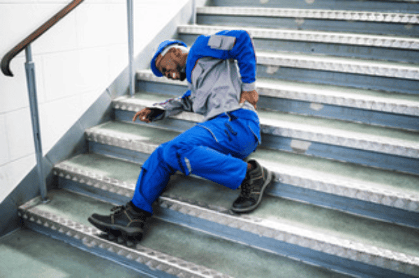 Man falls down stairs and injures back while wearing work uniform.